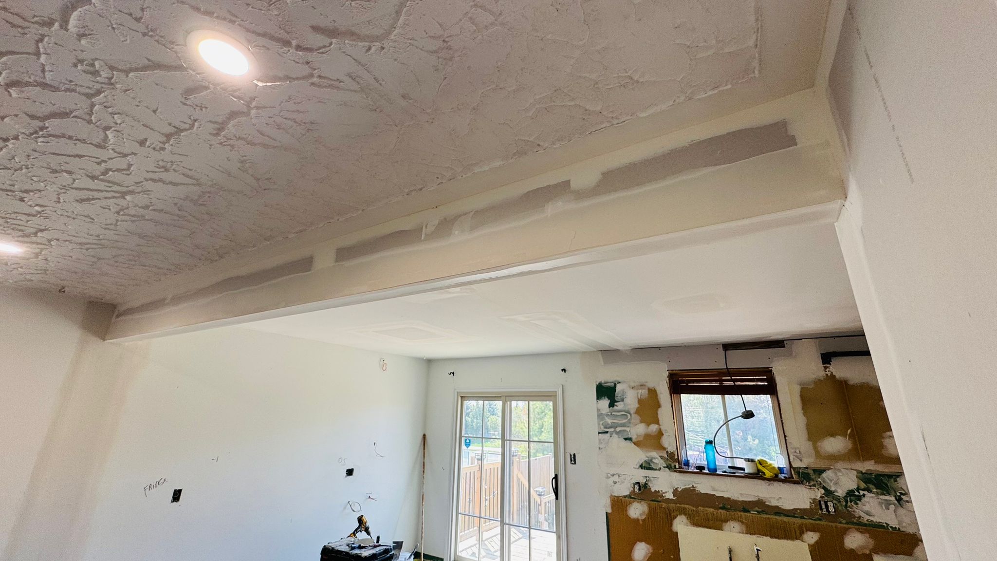 The same space mid-renovation with the old ceiling stripped back